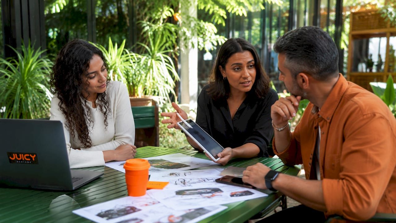 Marketing team discussing automotive ads at table