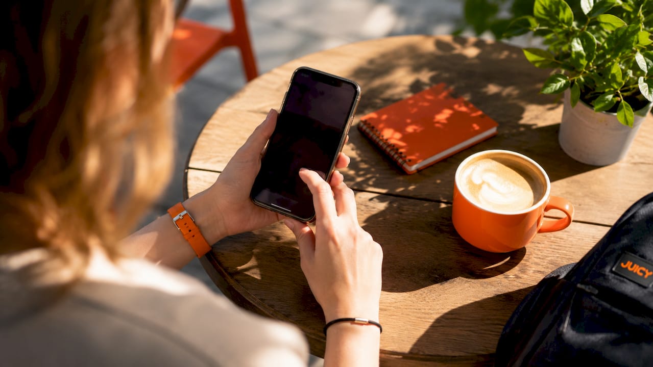 Close-up hands browsing retail content on smartphone