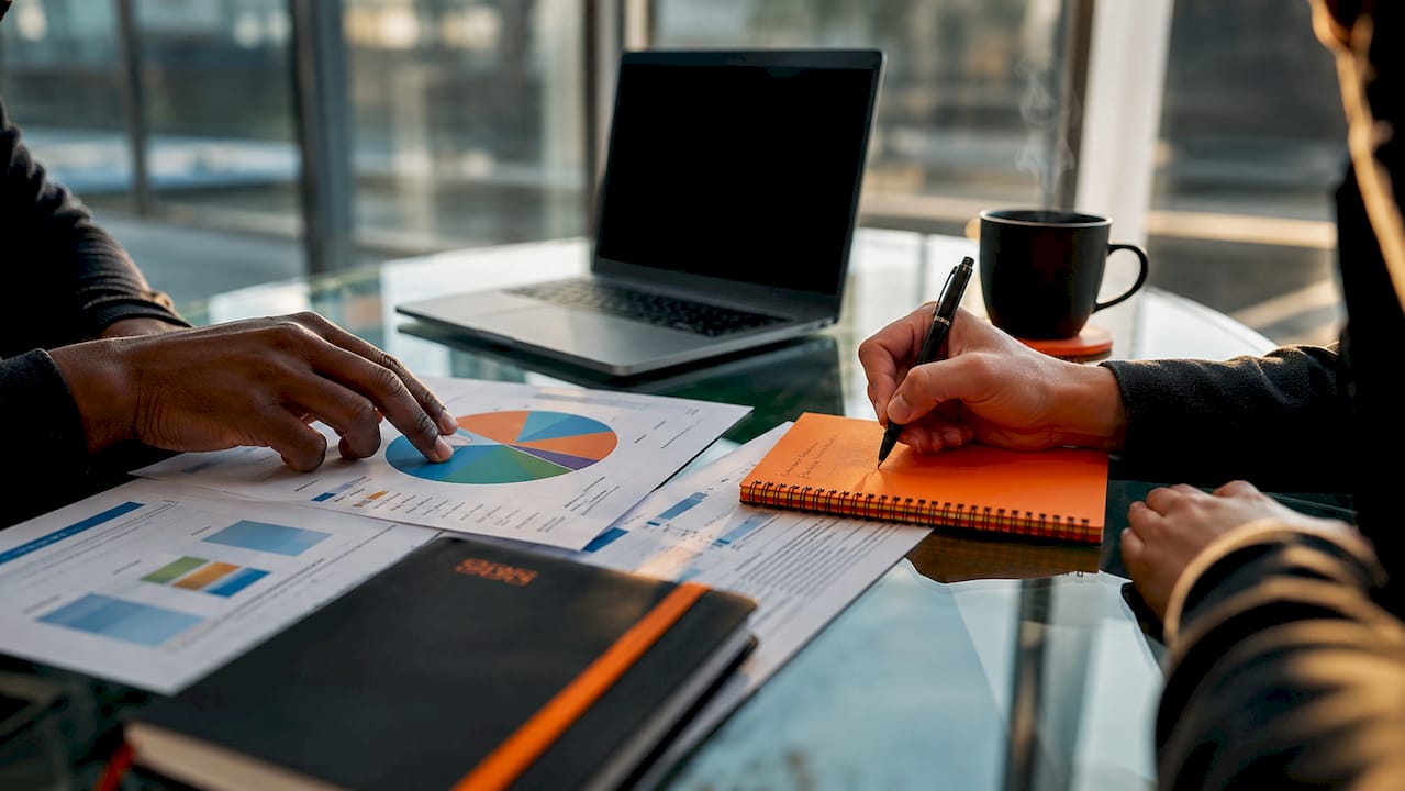 Hands working on paid search keyword bidding strategy