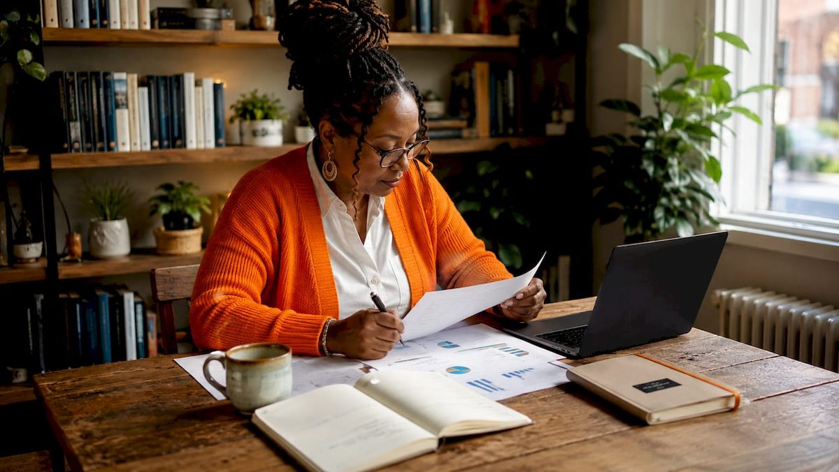 Woman reviewing digital marketing reports at home office